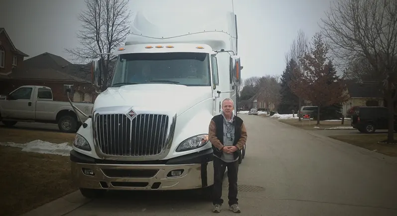 Terry from a-zip standing in front of a white truck